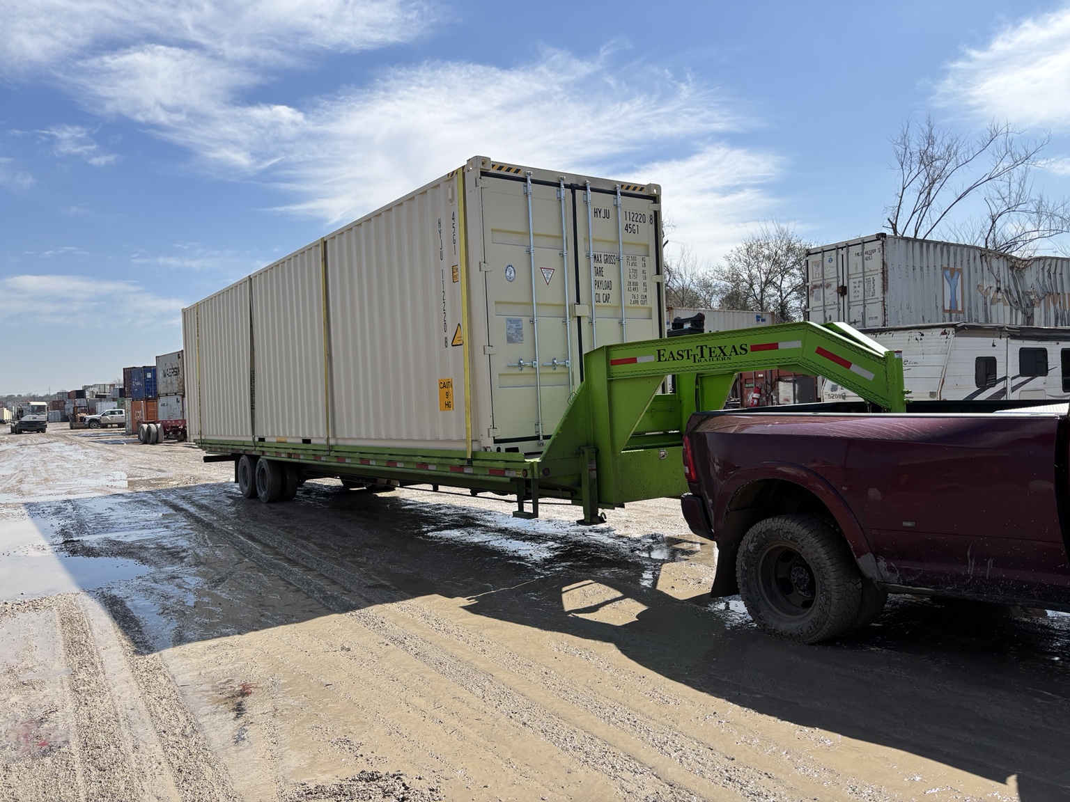 J-Tex delivery truck and trailer hauling a shipping container